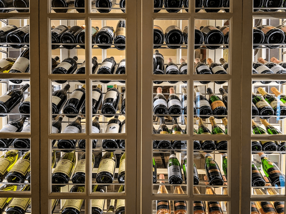 Wine bottles stored in a glass cabinet horizontally