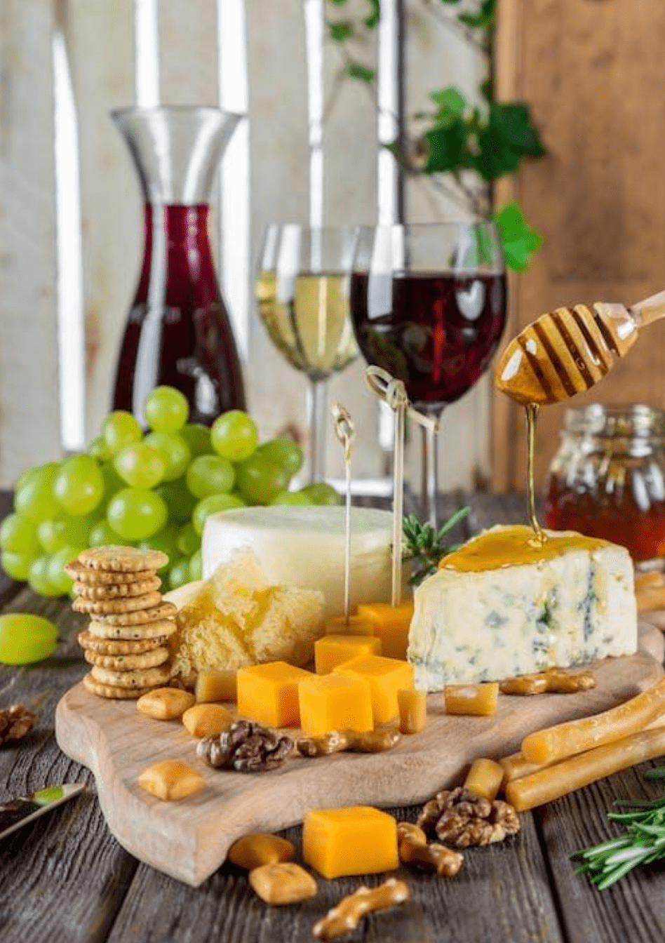 Glasses of wine next to a cheese board